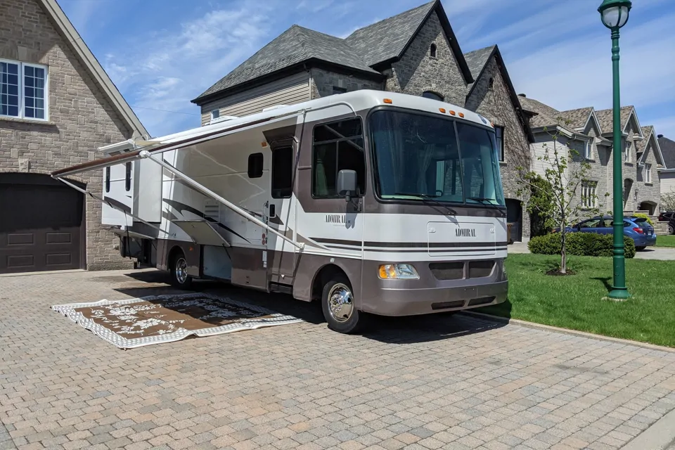 Class A Holiday Rambler parked in a driveway